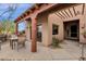 Covered patio with dining table and chairs. The exterior of the house is visible in the background at 11686 N Spotted Horse Way, Fountain Hills, AZ 85268