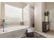 Tranquil bathroom featuring a soaking tub, a walk-in shower, and stylish decor at 12320 W Lone Tree Trl, Peoria, AZ 85383