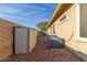 Side yard with storage unit and AC units, set on gravel base at 12320 W Lone Tree Trl, Peoria, AZ 85383