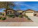 Charming single-story home featuring a well-manicured front yard and a two-car garage at 12320 W Lone Tree Trl, Peoria, AZ 85383