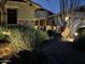 Charming front yard featuring desert landscaping with decorative lighting, creating a warm and inviting entrance at 12320 W Lone Tree Trl, Peoria, AZ 85383