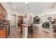 Open kitchen featuring granite countertops, a central island, and seamless flow into the living area at 12320 W Lone Tree Trl, Peoria, AZ 85383