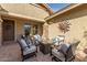 Inviting outdoor patio with comfortable seating and a stylish sunburst wall decoration at 12320 W Lone Tree Trl, Peoria, AZ 85383