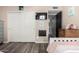 Bright bedroom with plank flooring, light pink bedding, white closet, and a mounted flat screen TV at 12402 N 36Th Dr, Phoenix, AZ 85029