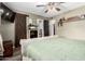 Bedroom showcasing plank flooring, barn door, flat screen TV, and decorative accents at 12402 N 36Th Dr, Phoenix, AZ 85029