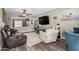 Cozy living room features a ceiling fan and a large TV at 12402 N 36Th Dr, Phoenix, AZ 85029