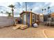 Backyard shed in the desert, complete with custom door, access ramp, and adjacent trampoline and shade trees at 12402 N 36Th Dr, Phoenix, AZ 85029