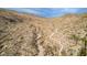 Panoramic aerial view of winding desert hiking path, arid vegetation, and community of homes in the valley at 1356 E Desert Flower Ln, Phoenix, AZ 85048