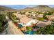 Aerial view of a home with a large pool, desert landscaping, and mountain views at 1356 E Desert Flower Ln, Phoenix, AZ 85048