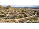 Wide aerial view of the community featuring desert landscape, many homes, and manicured lawns at 1356 E Desert Flower Ln, Phoenix, AZ 85048