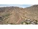 Scenic aerial view of desert community homes nestled near mountains with walking path at 1356 E Desert Flower Ln, Phoenix, AZ 85048