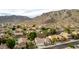 An aerial view of a residential community with mountain views and many desert plants at 1356 E Desert Flower Ln, Phoenix, AZ 85048