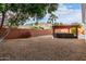 Expansive backyard with a pergola-covered seating area, mountain views, and mature trees at 1356 E Desert Flower Ln, Phoenix, AZ 85048