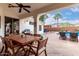 Covered patio with dining table, chairs, backyard, pool, and pergola at 1356 E Desert Flower Ln, Phoenix, AZ 85048