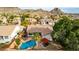 Aerial view of backyard pool, covered patio, and lush landscaping create a private oasis at 1356 E Desert Flower Ln, Phoenix, AZ 85048