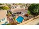 Aerial view of a private backyard with a swimming pool, lounge chairs and a covered patio at 1356 E Desert Flower Ln, Phoenix, AZ 85048