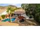 Aerial view of the backyard with a sparkling pool, covered patio, lush landscaping, and a seating area at 1356 E Desert Flower Ln, Phoenix, AZ 85048