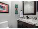 Charming powder room with granite counters, decorative art, and a dark wood vanity at 1356 E Desert Flower Ln, Phoenix, AZ 85048