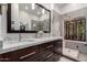 Elegant bathroom with marble countertops, dual sinks, and a tiled shower at 1356 E Desert Flower Ln, Phoenix, AZ 85048