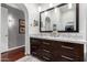 Elegant bathroom featuring a marble countertop with a spacious dark-wood vanity and closet at 1356 E Desert Flower Ln, Phoenix, AZ 85048