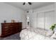 Cozy bedroom with dark wood flooring, closet, a neutral color scheme, and natural light at 1356 E Desert Flower Ln, Phoenix, AZ 85048