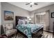 Cozy bedroom with natural light, patterned bedding, and ceiling fan at 1356 E Desert Flower Ln, Phoenix, AZ 85048