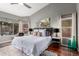 Bright bedroom featuring hardwood floors, stylish decor, and a ceiling fan at 1356 E Desert Flower Ln, Phoenix, AZ 85048