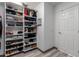 Organized walk-in closet featuring built-in shelving and ample storage space for clothing and accessories at 1356 E Desert Flower Ln, Phoenix, AZ 85048