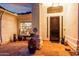 Covered entryway featuring a security door, potted plants, and decorative window at 1356 E Desert Flower Ln, Phoenix, AZ 85048