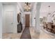 Bright foyer with decorative lighting, travertine tile, and views to dining room at 1356 E Desert Flower Ln, Phoenix, AZ 85048