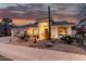 Charming home exterior with desert landscaping, arched entry, and a warm sunset glow at 1356 E Desert Flower Ln, Phoenix, AZ 85048