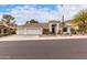 Inviting single-story home features a three-car garage, tile roof, and desert landscaping at 1356 E Desert Flower Ln, Phoenix, AZ 85048