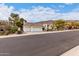 Inviting single-story home features a three-car garage, tile roof, and desert landscaping at 1356 E Desert Flower Ln, Phoenix, AZ 85048