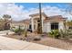 Inviting single-story home features a three-car garage, tile roof, and desert landscaping at 1356 E Desert Flower Ln, Phoenix, AZ 85048