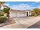 Inviting single-story home features a three-car garage, tile roof, and desert landscaping at 1356 E Desert Flower Ln, Phoenix, AZ 85048