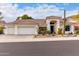 Inviting single-story home features a three-car garage, tile roof, and desert landscaping at 1356 E Desert Flower Ln, Phoenix, AZ 85048