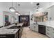 Open kitchen showcasing a spacious island with cooktop, modern cabinets, and a view into the dining area at 1356 E Desert Flower Ln, Phoenix, AZ 85048