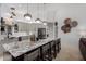 Well-lit kitchen featuring a large island with seating, modern appliances, and stylish pendant lighting at 1356 E Desert Flower Ln, Phoenix, AZ 85048