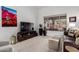 Bright living room featuring a large window, stylish furniture, and modern decor at 1356 E Desert Flower Ln, Phoenix, AZ 85048