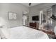 Serene main bedroom with hardwood floors, sliding glass doors, and a minimalist design at 1356 E Desert Flower Ln, Phoenix, AZ 85048