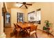 Covered patio with an outdoor dining area featuring a wooden table, chairs, and neutral decor at 1356 E Desert Flower Ln, Phoenix, AZ 85048