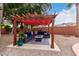 Inviting outdoor seating area under a charming pergola with comfortable seating and a fire pit at 1356 E Desert Flower Ln, Phoenix, AZ 85048