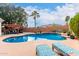 Inviting pool featuring an outdoor lounge, desert landscape, and comfortable deck chairs at 1356 E Desert Flower Ln, Phoenix, AZ 85048