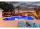 Sparkling pool with deck chairs surrounded by lush landscaping and a relaxing pergola lounge at 1356 E Desert Flower Ln, Phoenix, AZ 85048