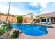 Inviting backyard pool is surrounded by lush landscaping and ample seating areas at 1356 E Desert Flower Ln, Phoenix, AZ 85048