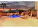 Beautiful backyard with pool, lounge chairs, and a beautiful desert landscape during sunset at 1356 E Desert Flower Ln, Phoenix, AZ 85048