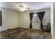 Bedroom with wood floors, ceiling fan, and window with curtains at 1391 E 12Th St, Casa Grande, AZ 85122