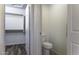 View of a closet and an adjacent toilet in a bathroom with dark vinyl flooring at 1391 E 12Th St, Casa Grande, AZ 85122