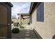 Exterior shot showing covered patio, landscaped yard, and tan stucco wall at 1391 E 12Th St, Casa Grande, AZ 85122