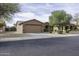 Single-story home featuring a two car garage, gravel landscaping and mature trees at 1391 E 12Th St, Casa Grande, AZ 85122